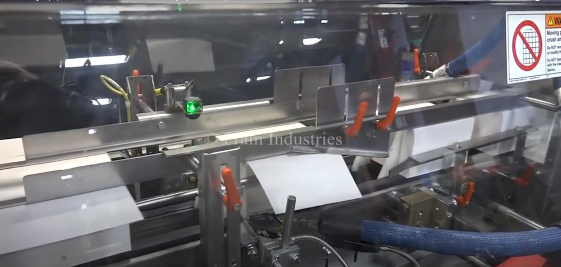 Packaging box sealing on an automated cartoning system.